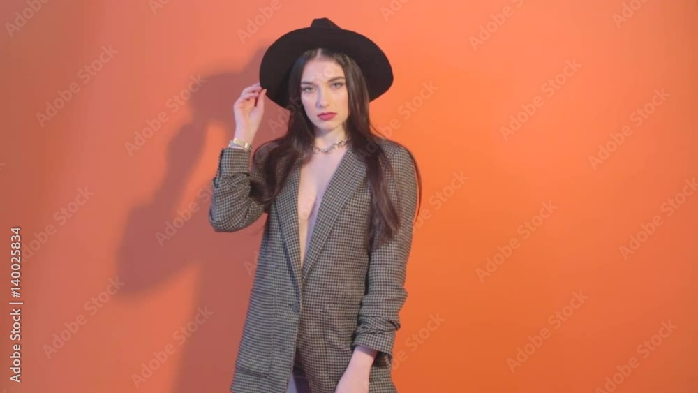 Young model in hat and jacket, and casting a shadow on the wall Young model in hat and jacket, and casting a shadow on the wall