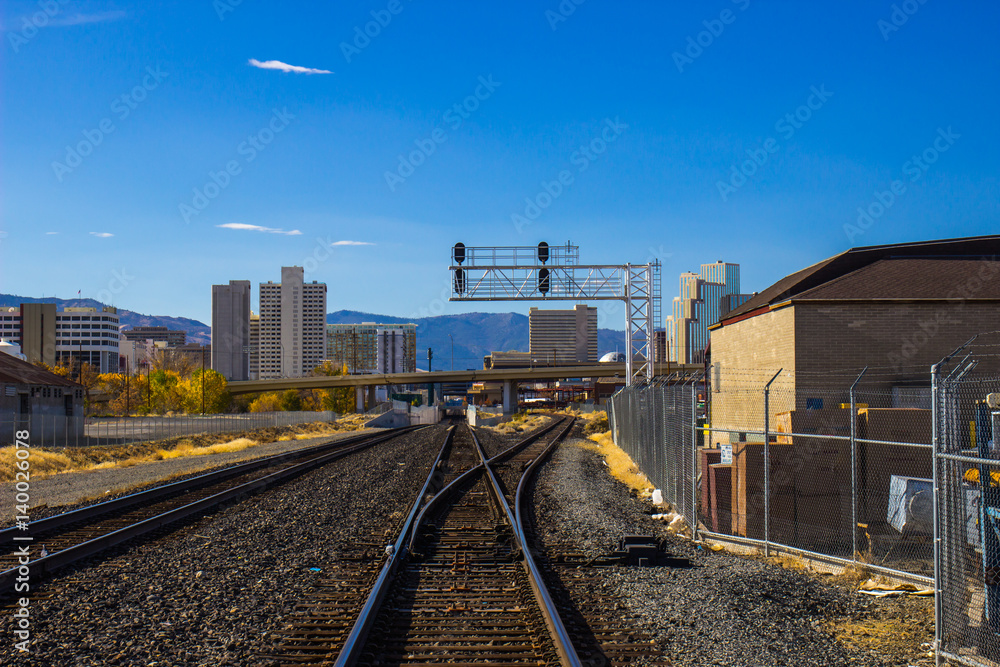 Fototapeta premium Railroad Tracks Leading Into City