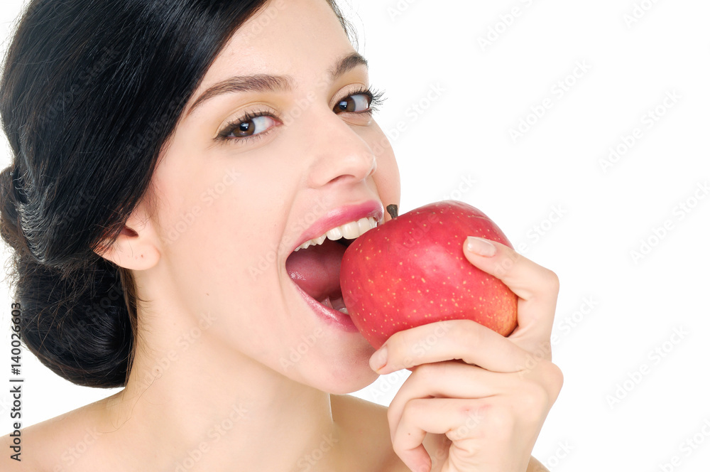 Young beautiful sexy girl with dark curly hair, bare shoulders and neck, holding big red apple to enjoy the taste and are dieting Young beautiful sexy girl with dark curly hair, bare shoulders and neck, holding big red apple to enjoy the taste and are dieting