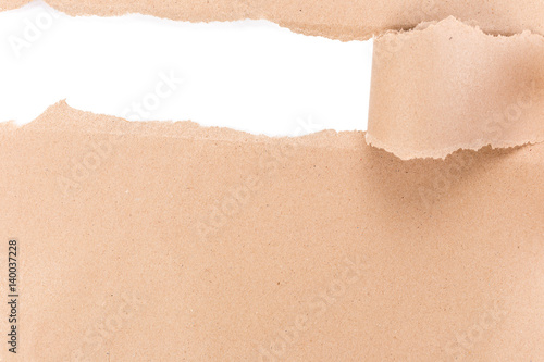 Hole ripped in brown paper on white background. © kaiskynet