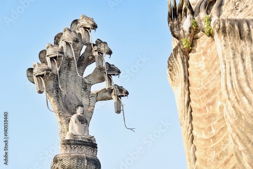 Ancient Naga Buddha Statue at Sala Kaew Ku in Nong Khai Province, Thailand photo