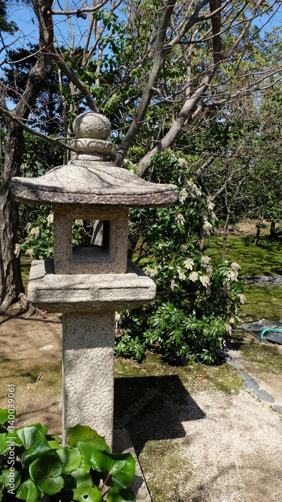 A toro - traditional Japanese stone lantern in a garden A toro - traditional Japanese stone lantern in a garden