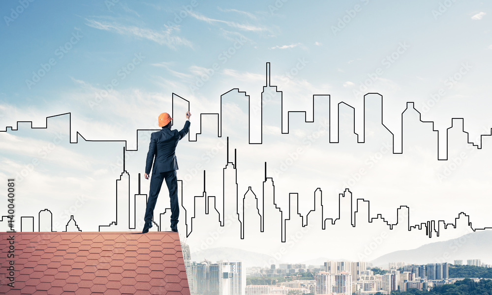 Man architect draw silhouette of modern city on blue sky. Mixed Man architect draw silhouette of modern city on blue sky. Mixed