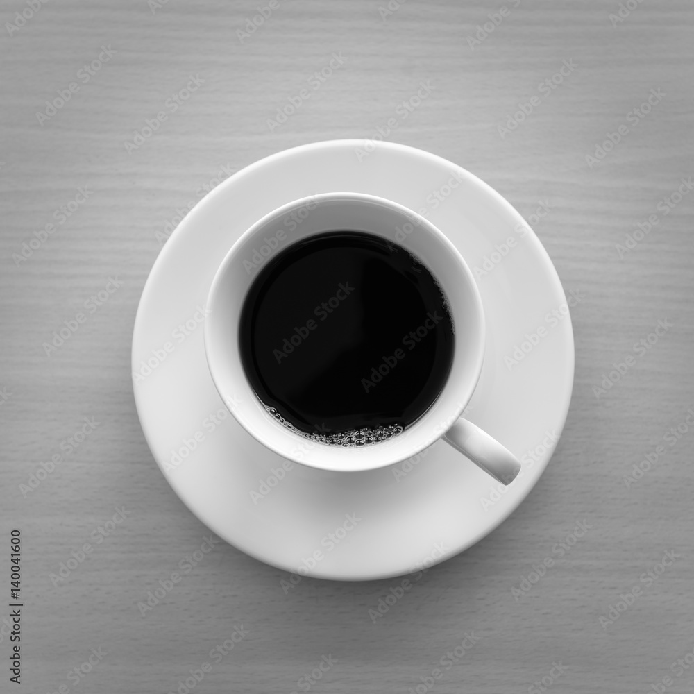 Top view of a cup of hot coffee on wooden table. back and white color. square shap Top view of a cup of hot coffee on wooden table. back and white color. square shap