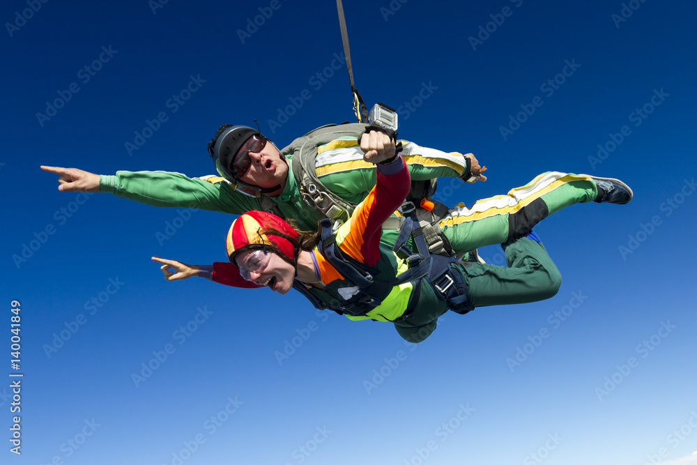 Tandem jump. The girl with the instructor in freefall. Tandem jump. The girl with the instructor in freefall.
