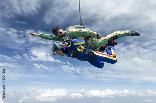 Tandem jump. The girl with the instructor in freefall.