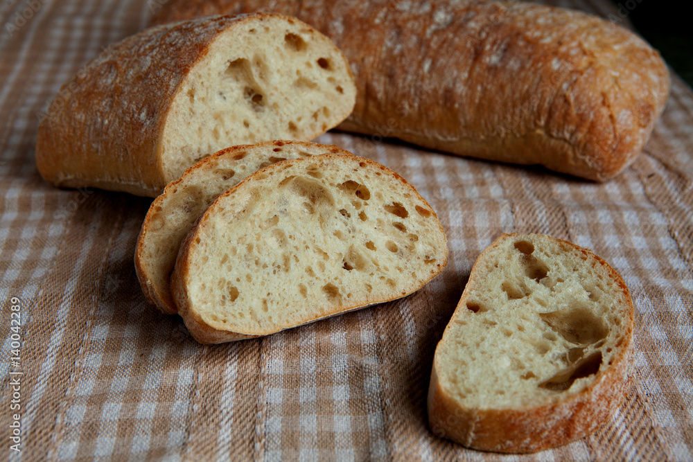 Naklejka premium Fresh sliced italian Ciabatta bread on background