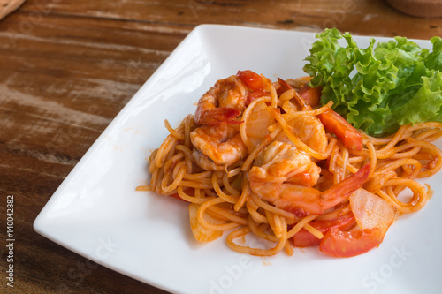 Close up stir fried spaghetti and prawn with tomato sauce