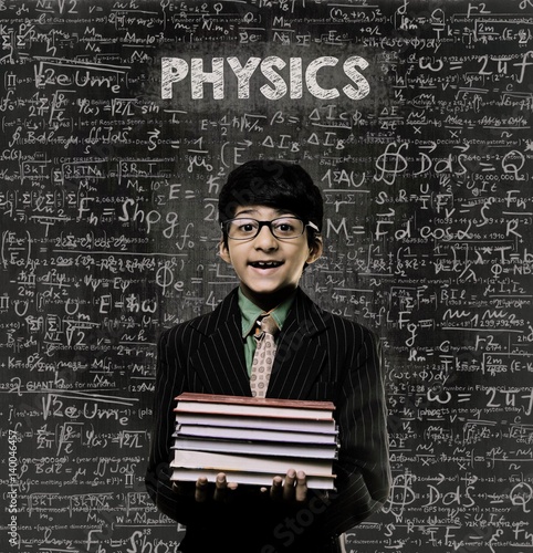 Physics. Genius Little Boy Holding Book Wearing Glasses Chalkboard photo