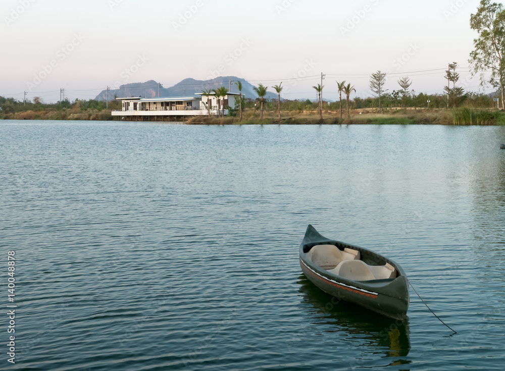 Fototapeta premium Small boat on Ticino lake at sunset, Thailand