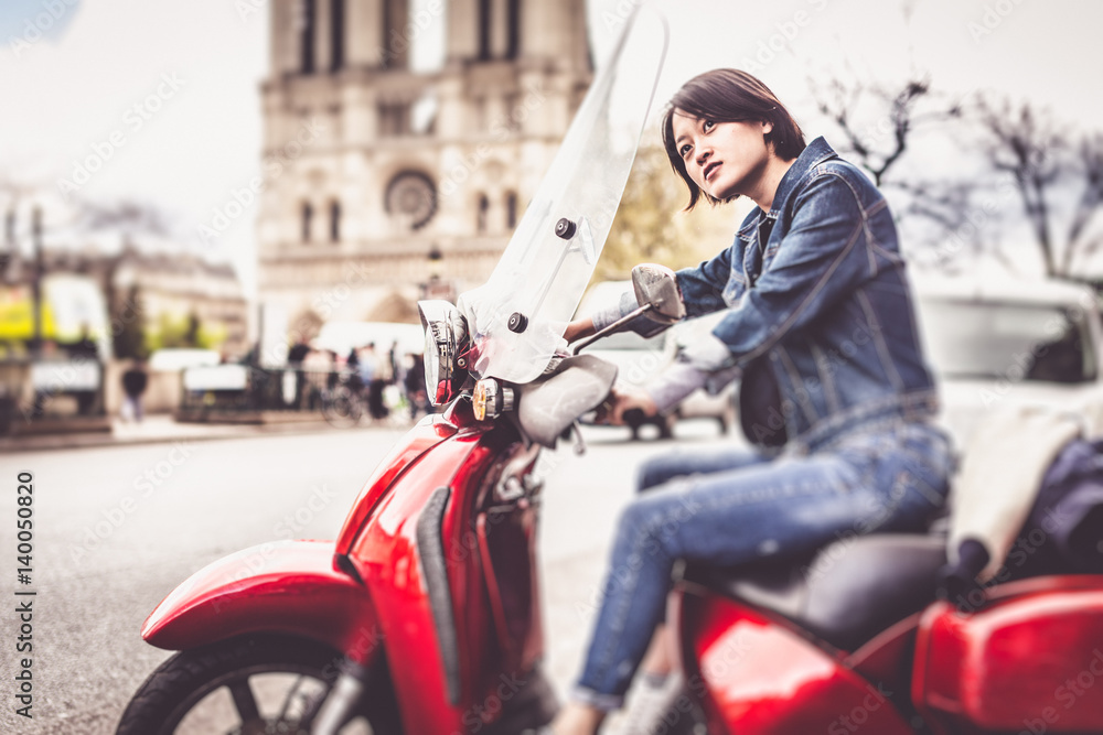 Young Chinese Female On Scooter In Paris