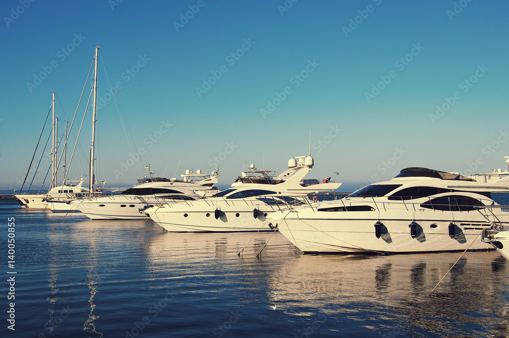 Fototapeta premium White yacht in the port waiting. On the sea is calm.