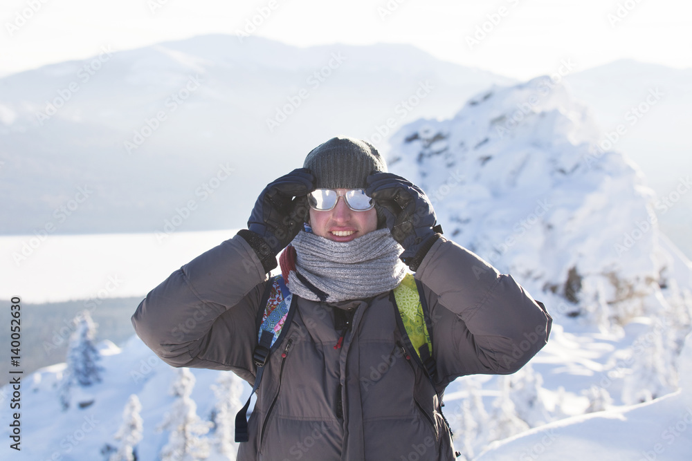Man near rocks. Mountain range Zyuratkul, winter
