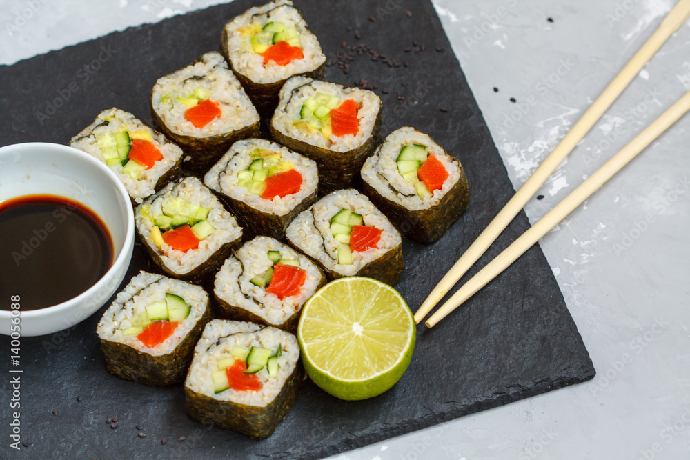 Healthy homemade sushi rolls with brown rice and fish. Healthy homemade sushi rolls with brown rice and fish.