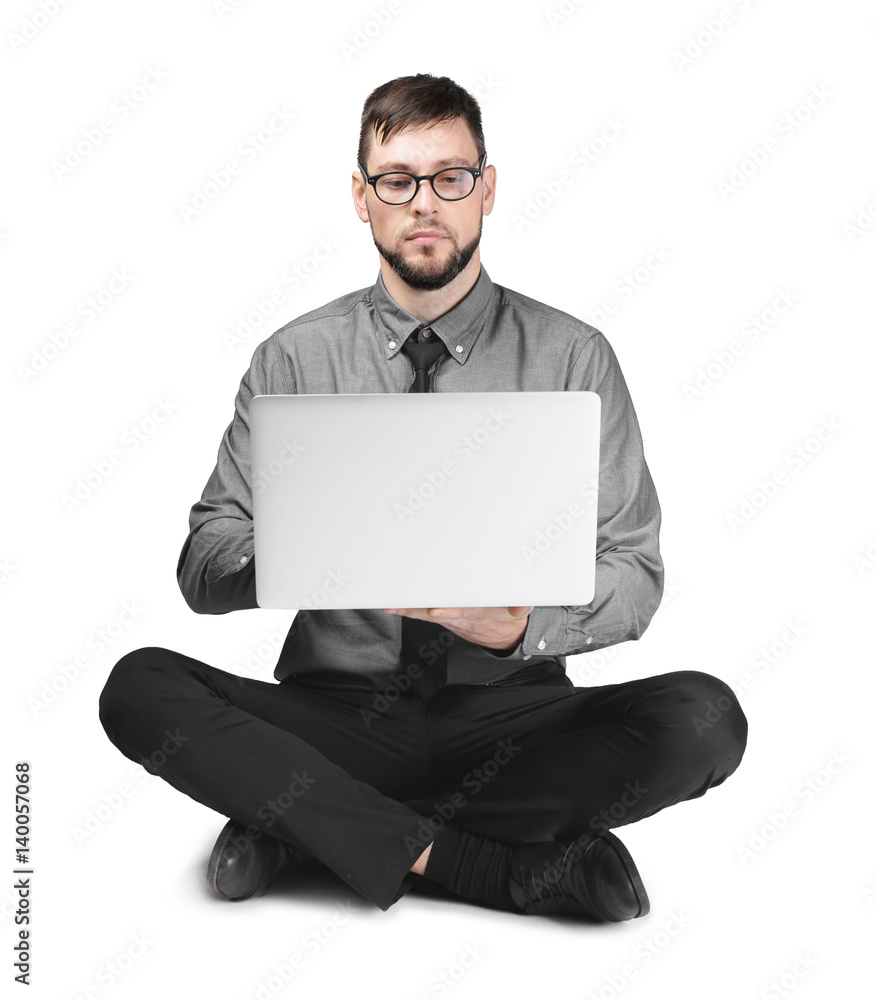 Handsome young programmer with laptop on light background Handsome young programmer with laptop on light background