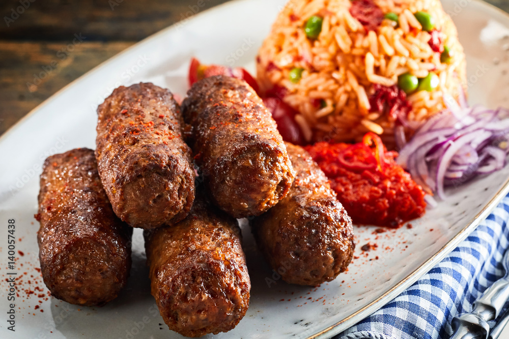 Fried spicy cevapcici meat patties with paprika
