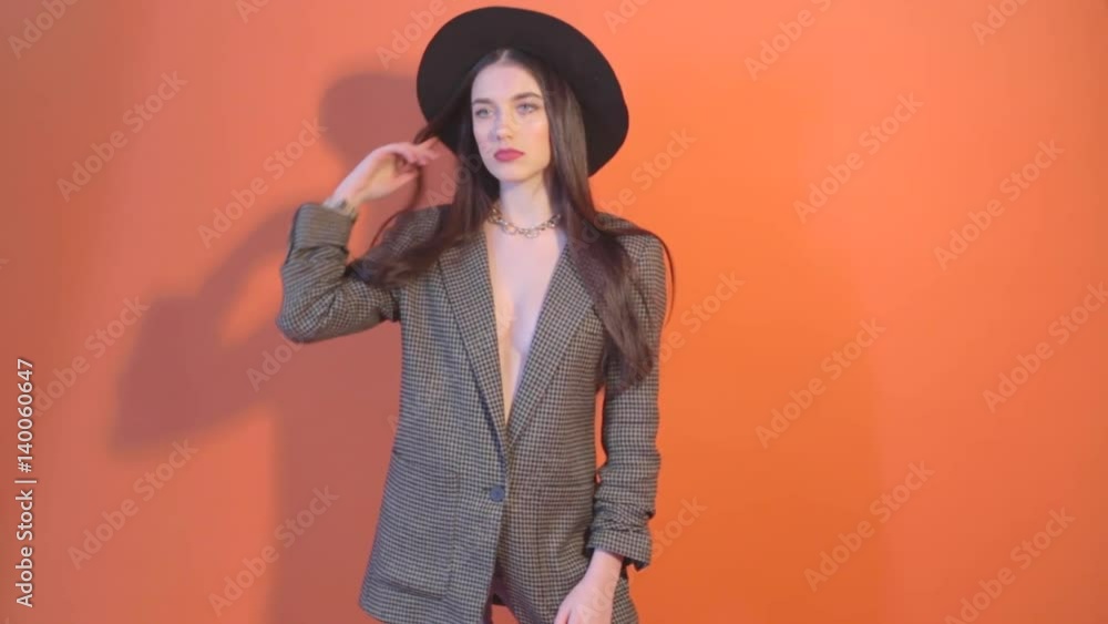Young model in hat and jacket, and casting a shadow on the wall Young model in hat and jacket, and casting a shadow on the wall