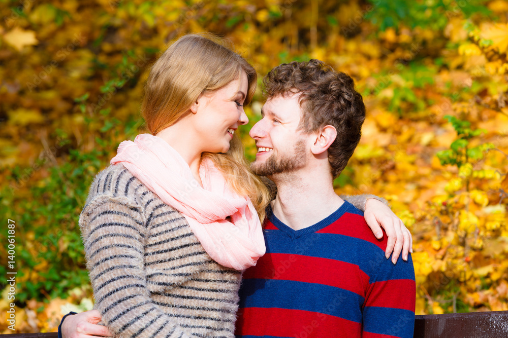 Lovers couple in autumn park on bench Lovers couple in autumn park on bench