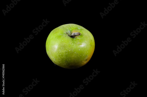 Green apple isolated on black