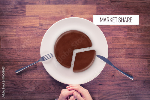 Market share - marketing business concept. Business visual metaphor - businessman with plate and pie chart with imitation of a chocolate cake and snippet with text Market Share. photo