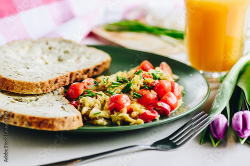 Scrambled eggs with cherry tomatoes and chili peppers