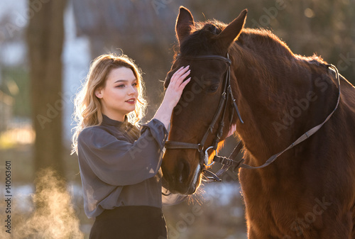 Young beautiful elegance woman posing with horse © Dusan Kostic
