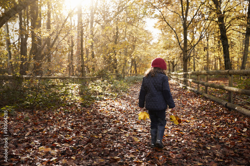 Young Girl Walking Along Path Through Autumn Countryside © Monkey Business