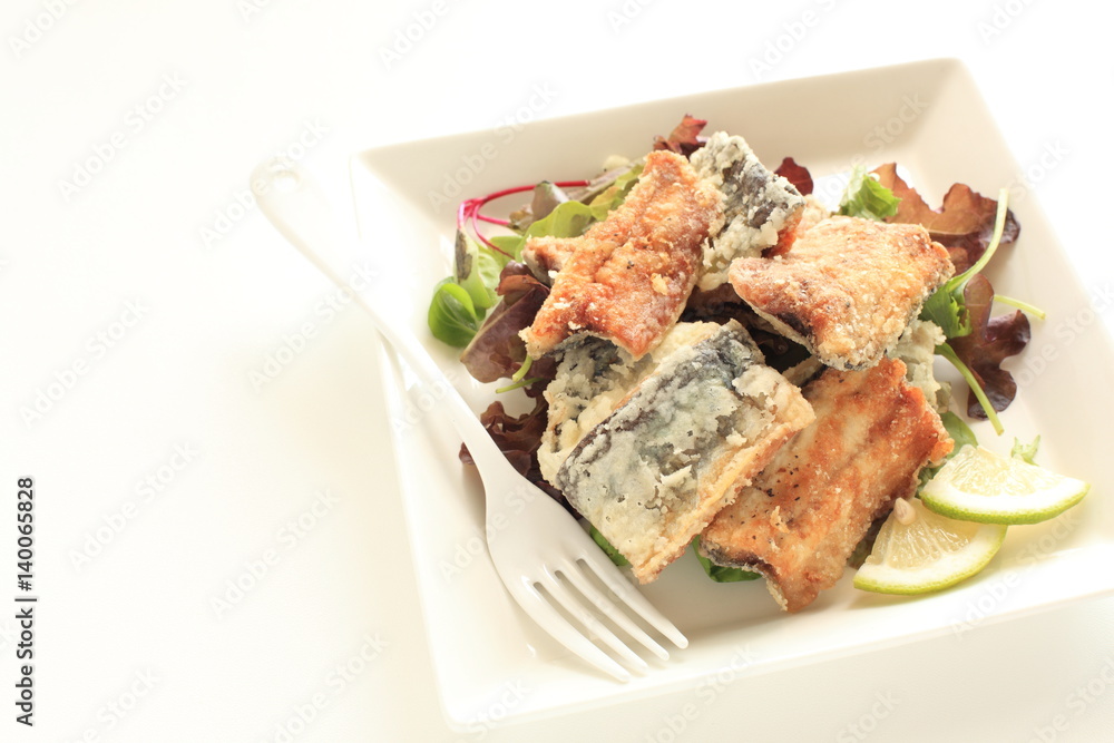 Japanese food, deep fried Sanma Pacific saury served with baby life and lemon