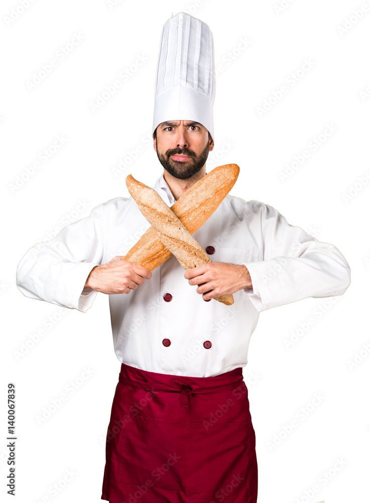 Young baker holding some bread making NO gesture Young baker holding some bread making NO gesture