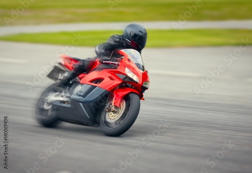 Fast motorbike racing on the race track at high speed.