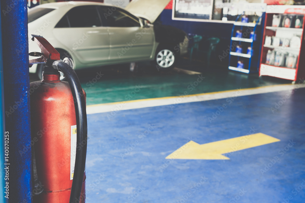fire extinguisher in car repair station, safety first concept Stock