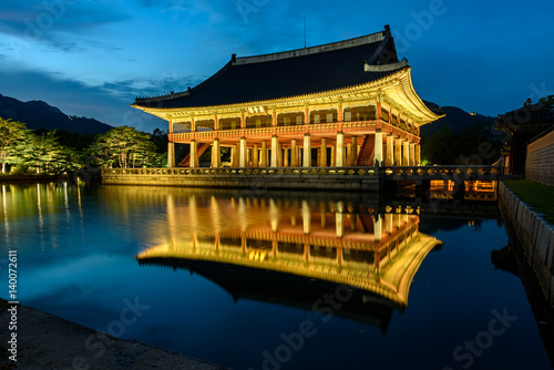 Gyeongbokgung Palace At Night In South Korea, with the name of the palace 'Gyeongbokgung' on a sign © Atakorn