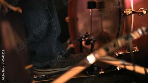 A drummer playing the bass drum with his foot photo