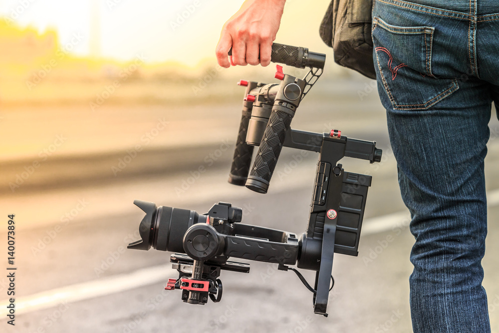 Videographer with gimbal video camera dslr, Professional video equipment, Videographer in event film production shoot video. - obrazy, fototapety, plakaty 