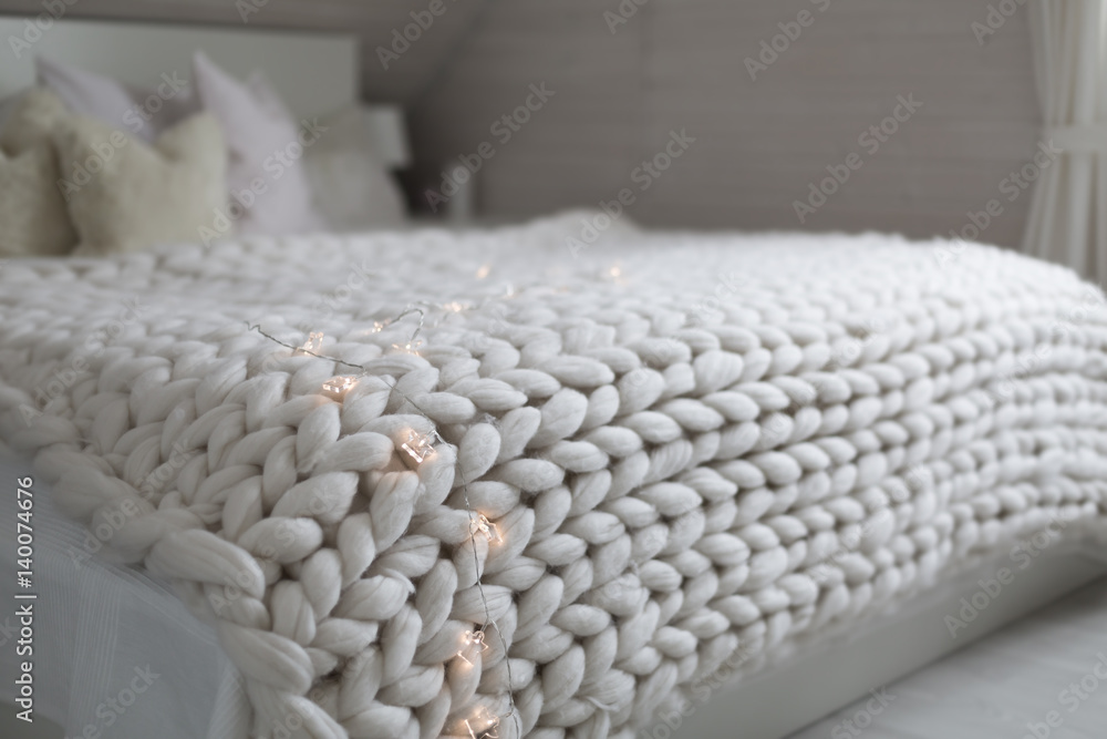 Fototapeta premium White nordic bedroom interior with knit plaid