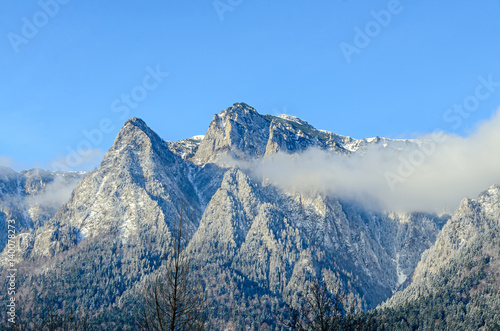 Carpathian mountains, Bucegi with Caraiman Peak, clouds, snow and fog, winter time landscape