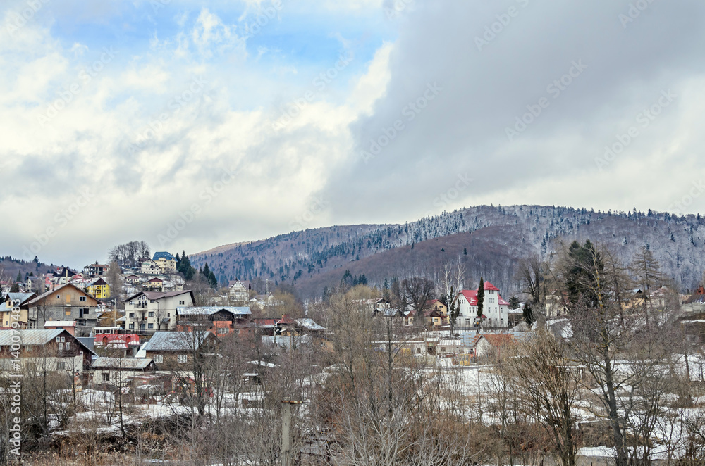 Romanian mountain city with colored houses, hotels and guest houses, pine forest