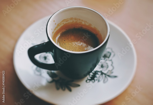 Cup of fresh morning espresso coffee with a beautiful thick tiger crema, close up view