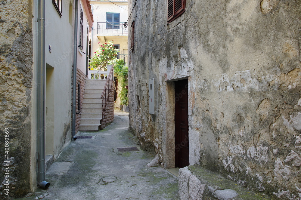Novi Vinodolski, Croatia: tourist resort situated on the Adriatic Sea in northern Croatia. The narrow street of the old city with buildings typical of the region.