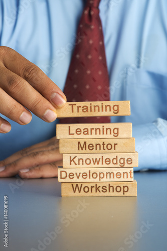 Hand arranging wood block concept of Training