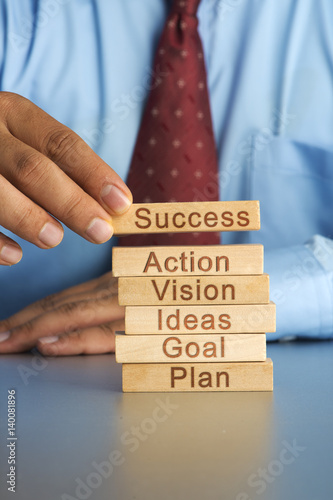 Hand arranging wood block stacking as step stair. Business concept for growth success process