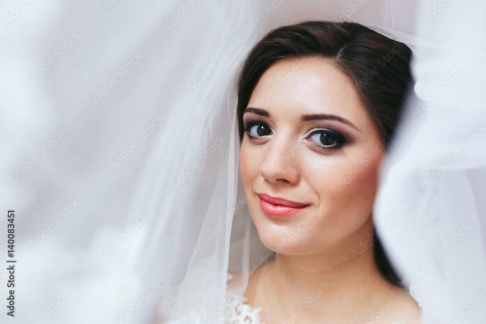 Birde's shiny face enveloped in delicate white veil Birde's shiny face enveloped in delicate white veil