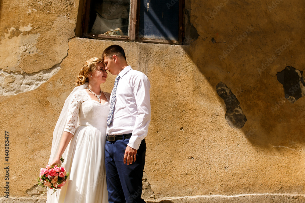 Sun shines over tender newlyweds holding each other hands Sun shines over tender newlyweds holding each other hands