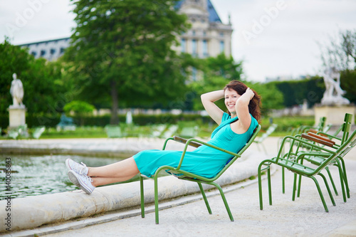 Beautiful young woman relaxing in Parisian Tuileries park