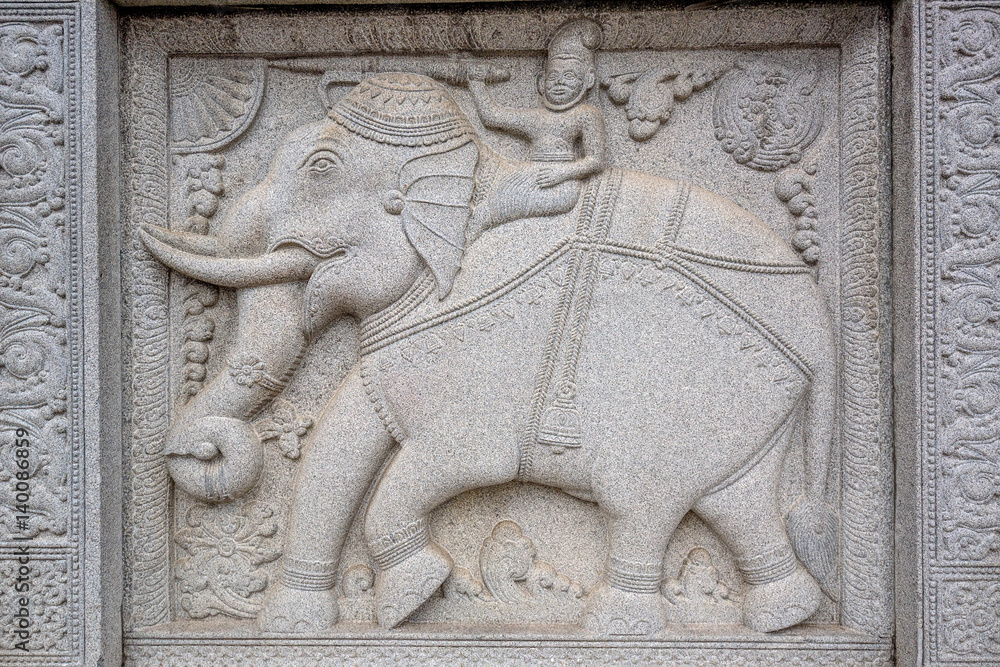Stone bas relief of elephants in buddhists' temple