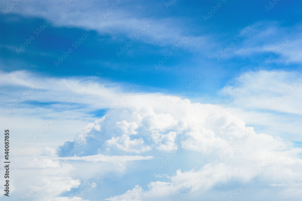 Airplane window seat view of big white thick fluffy clouds with a clear blue sky at the background in the afternoon. Airplane window seat view of big white thick fluffy clouds with a clear blue sky at the background in the afternoon.