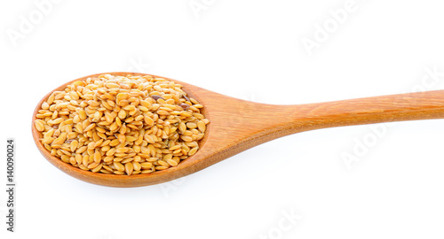 Flax seeds heap in wood spoon isolated on white background