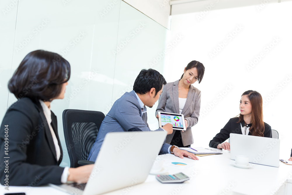 Business partners discussing documents and ideas at meeting Business partners discussing documents and ideas at meeting
