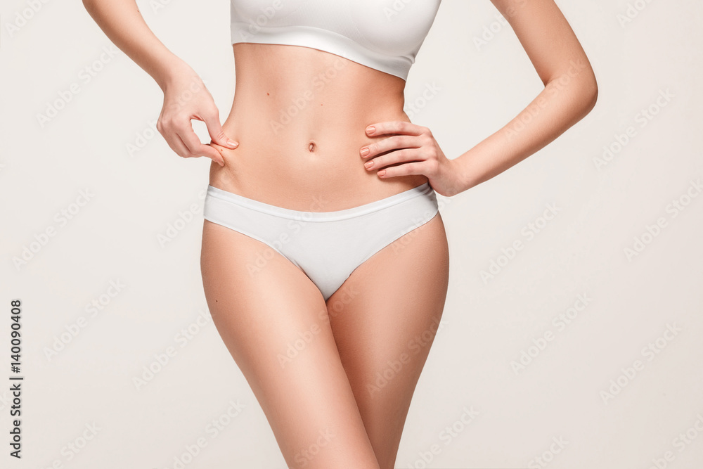 Fototapeta premium Young, slim, healthy and beautiful woman in white lingerie