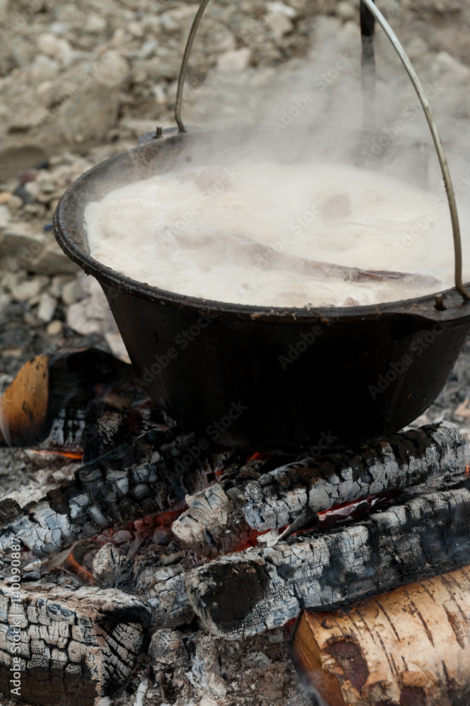 Lamb cooked in an iron cauldron in the camp Lamb cooked in an iron cauldron in the camp